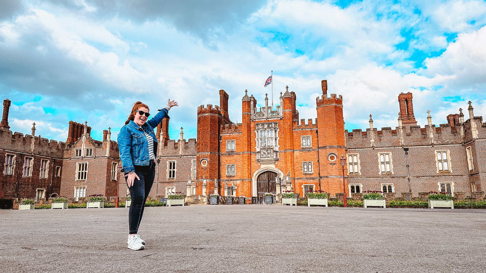female standing in front of Hampton Court Palace London, England